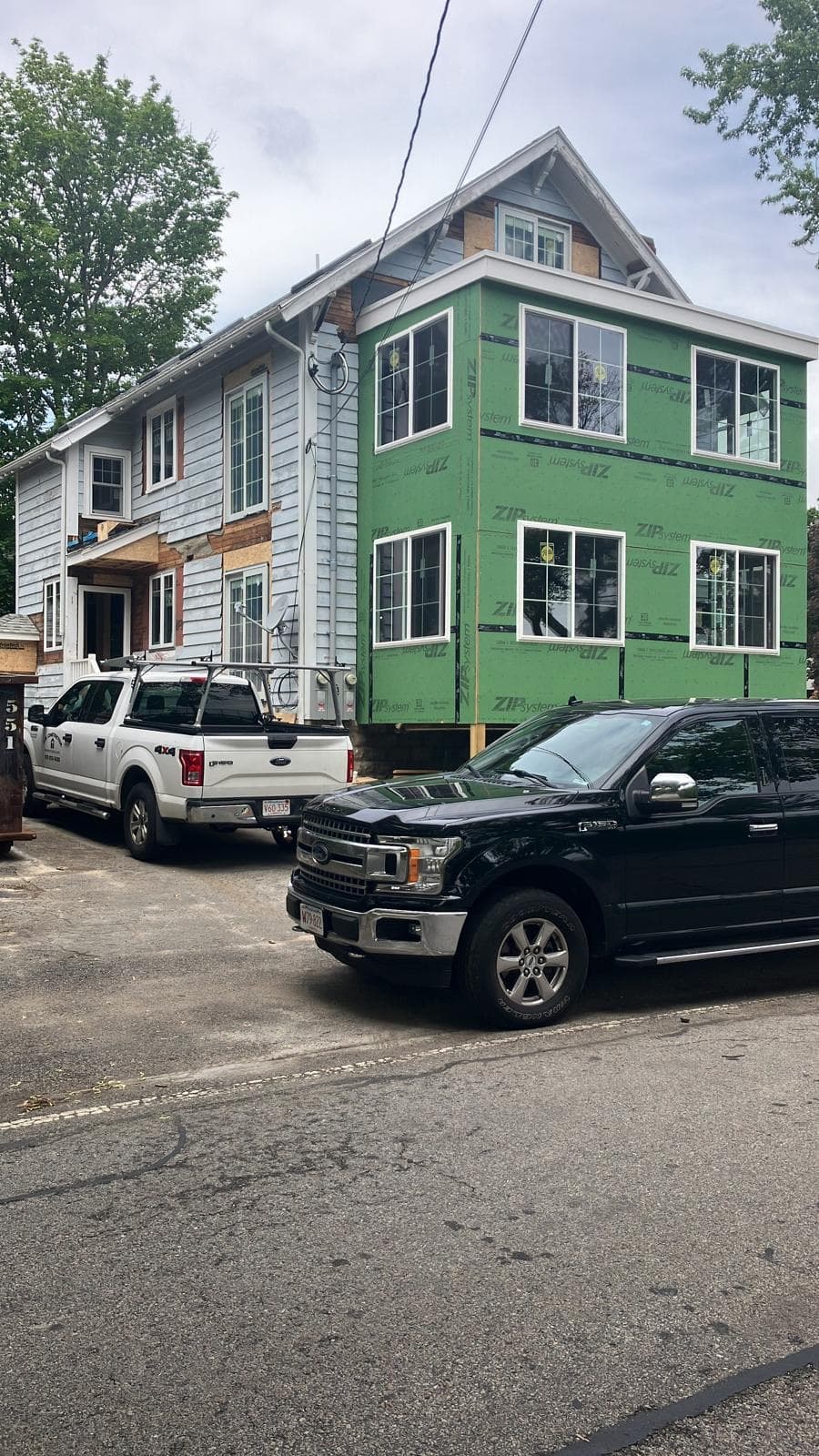 Three-story home mid-project with new siding over ZIP sheathing