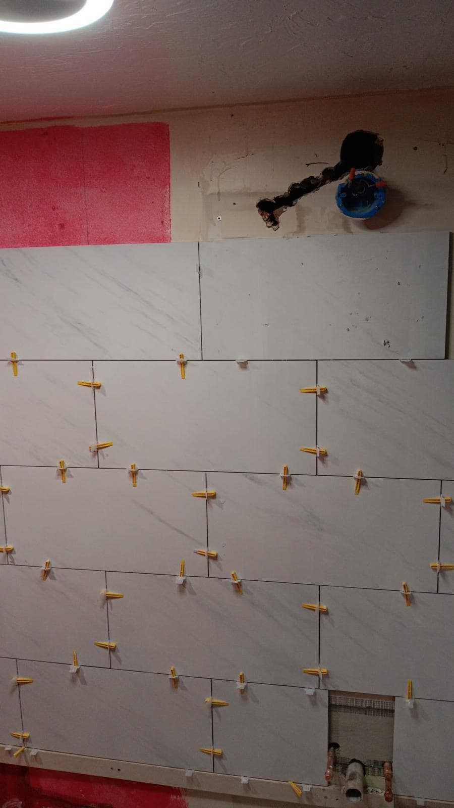 Marble subway tile shower wall going up