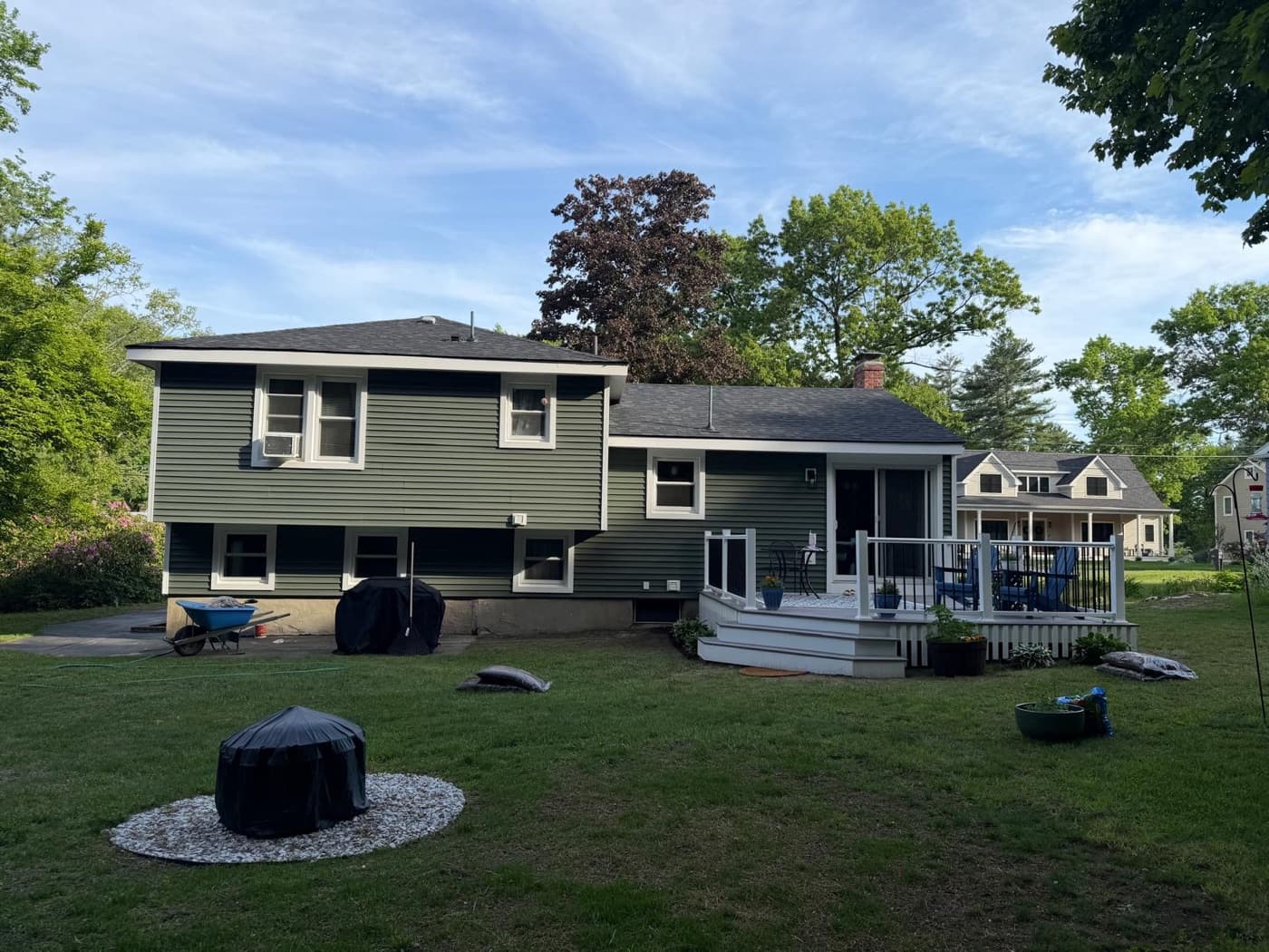 Rear view showing new siding and white deck with black railings