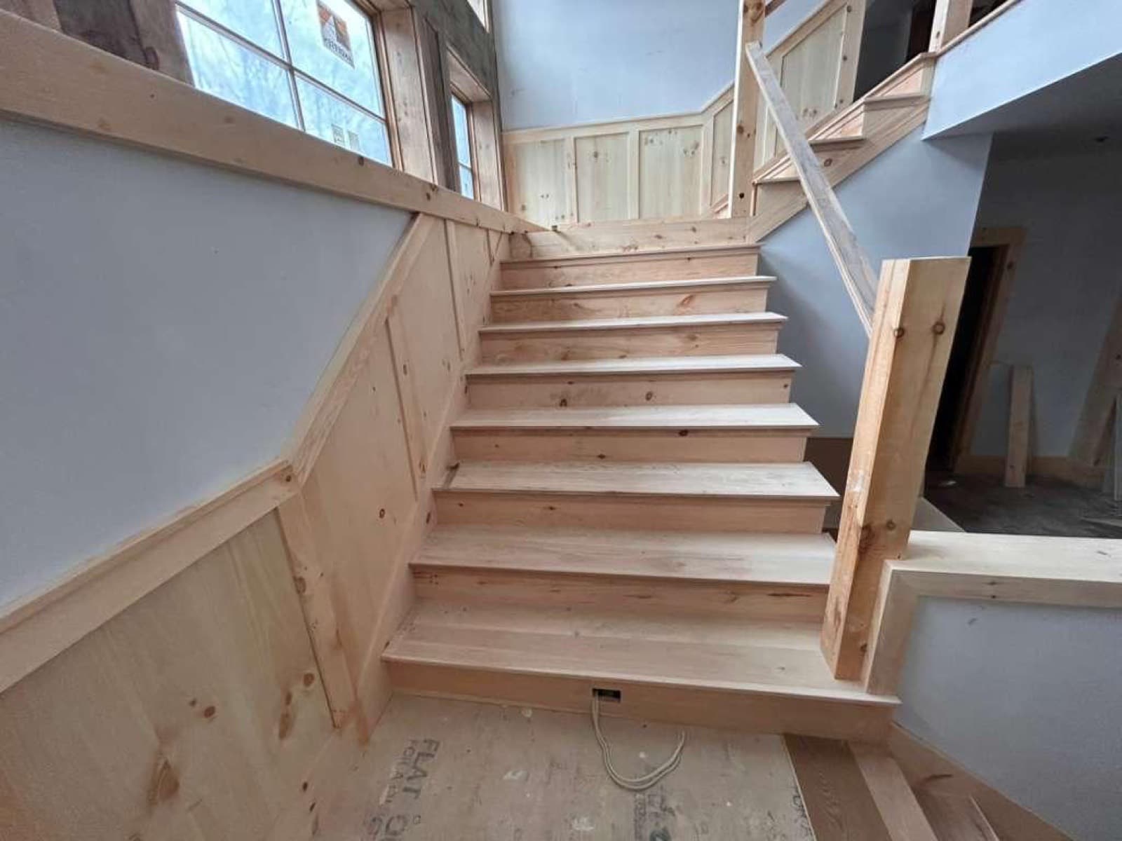 Custom pine staircase with full wainscoting